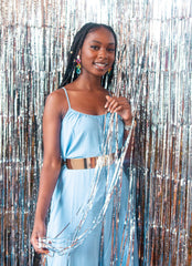 model wearing fiesta colorful circle link drop earrings stood infront of a silver sparkly curtain background