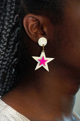 Close up on ear shot of a female model wearing star earrings made in Uganda